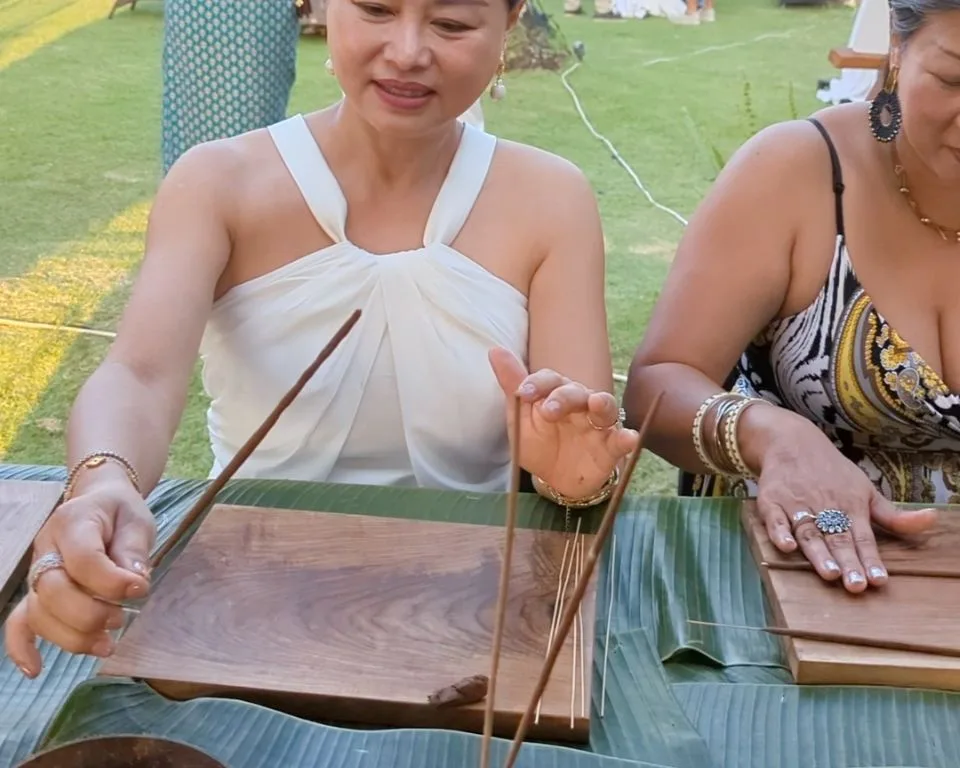 Wedding guests making incense together at the booth