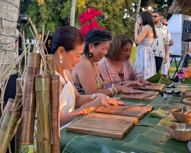 Wedding guests rolling incense at an event booth