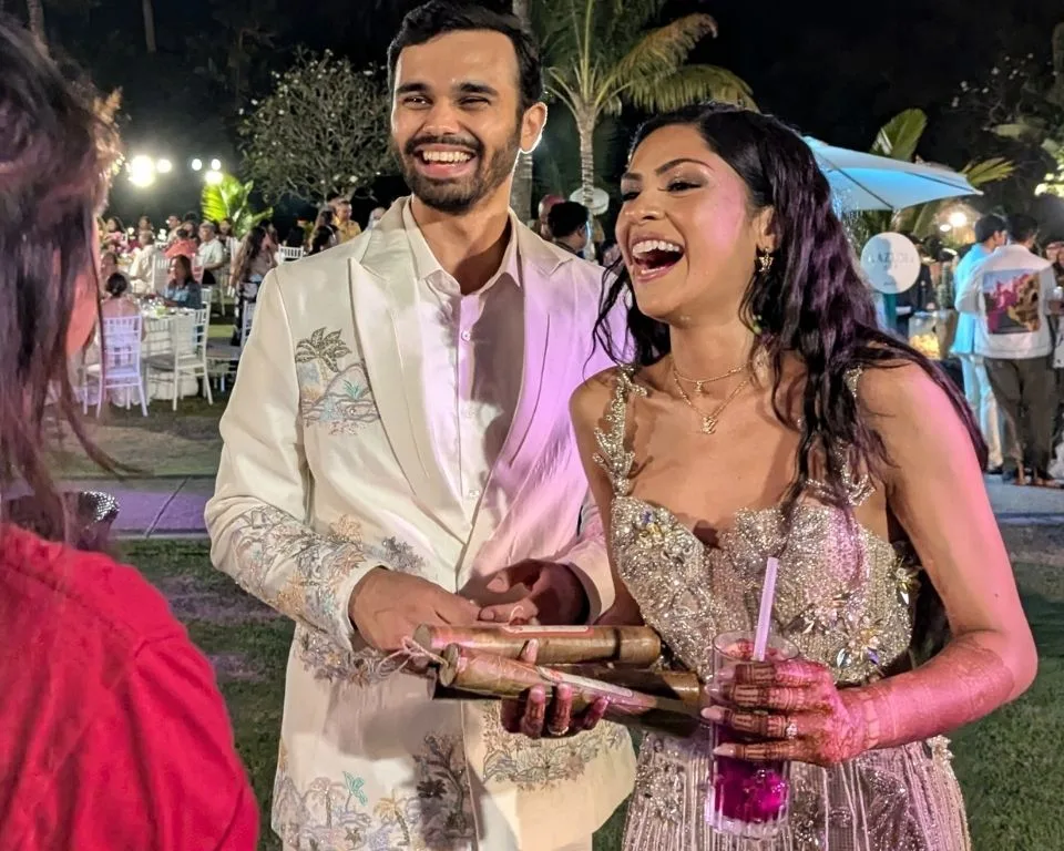 A bride and groom enjoying the incense booth at their wedding