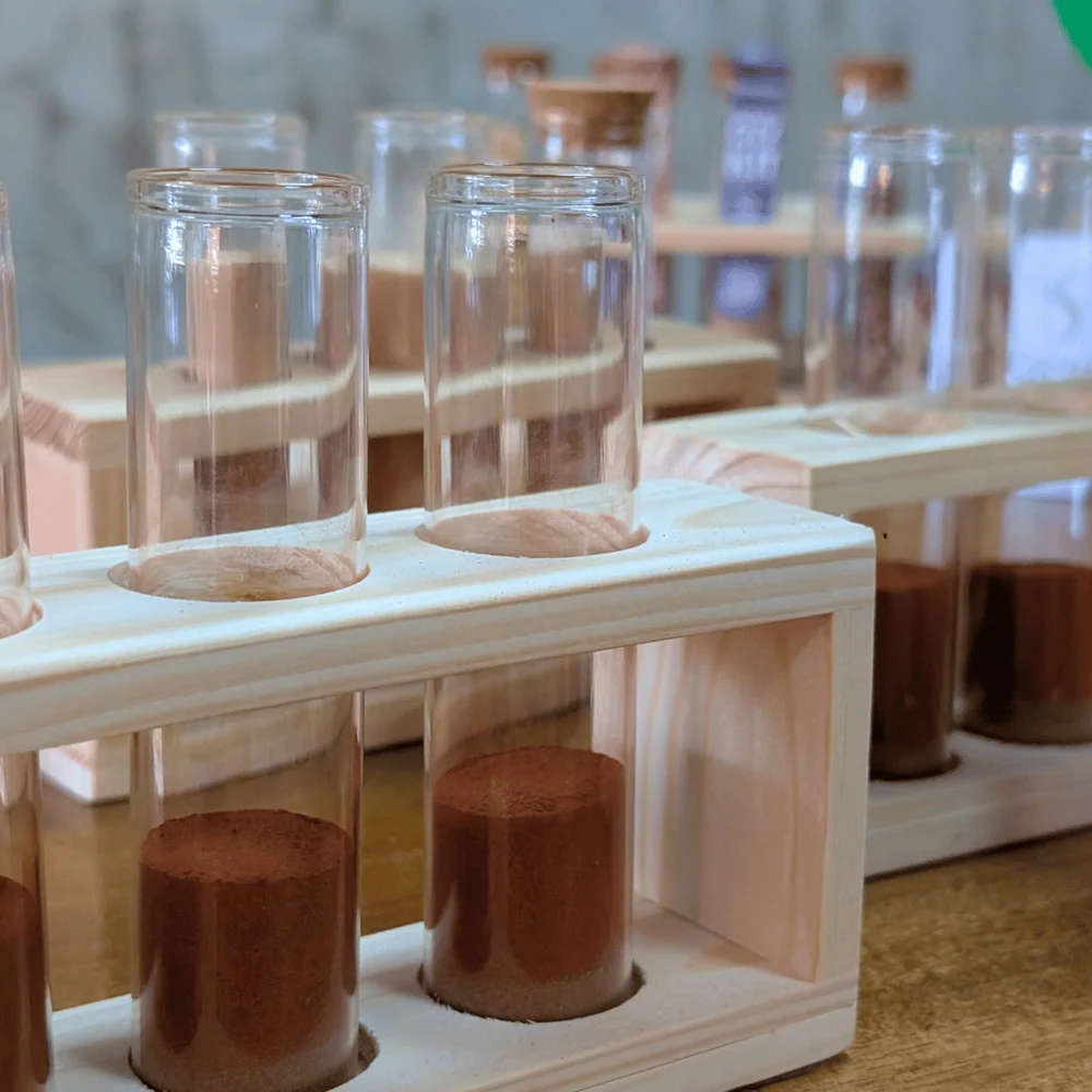 Glass vials filled with incense powders in wooden racks