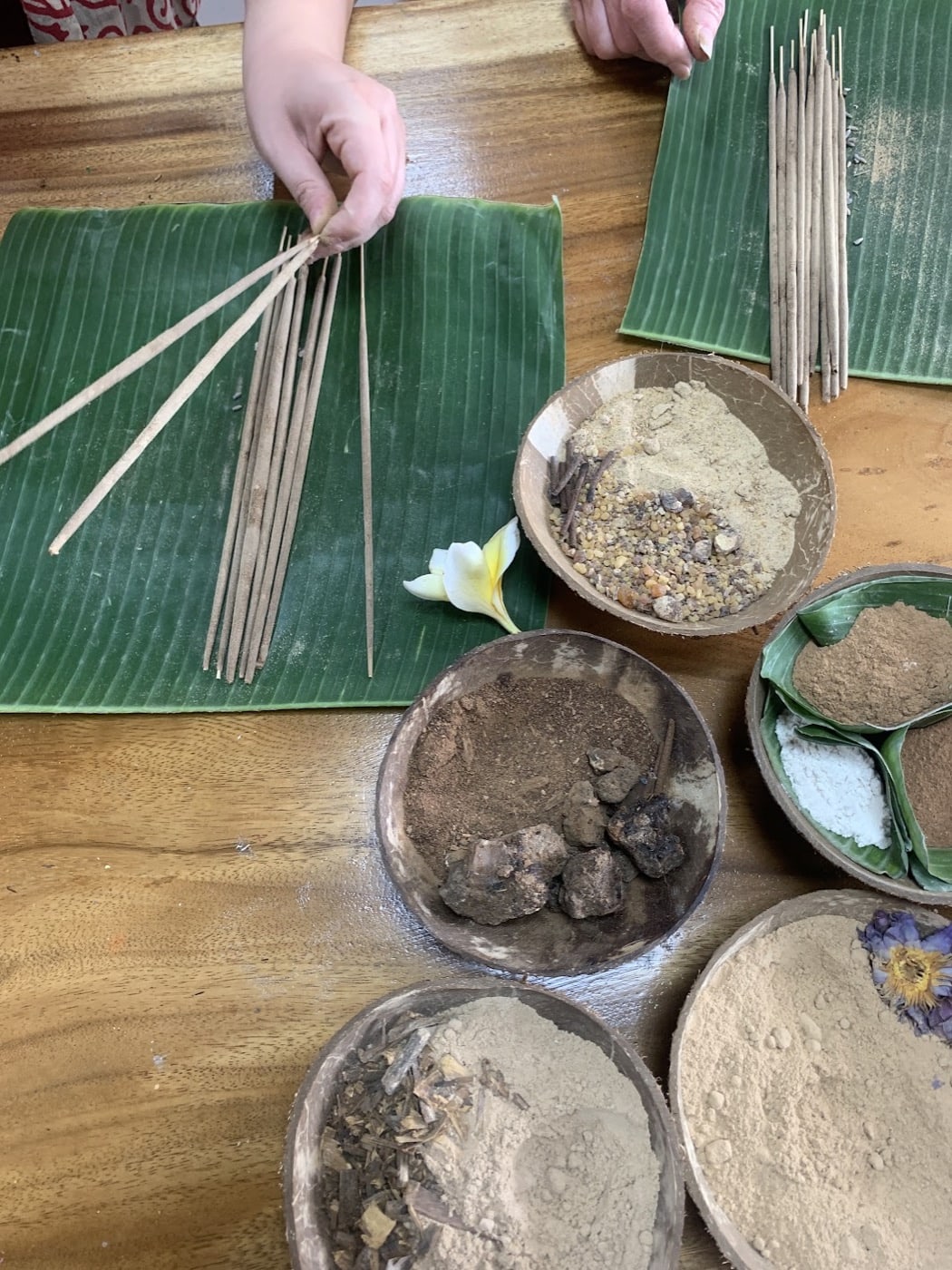 Hands preparing incense materials at the Sacred Smoke workshop in Ubud