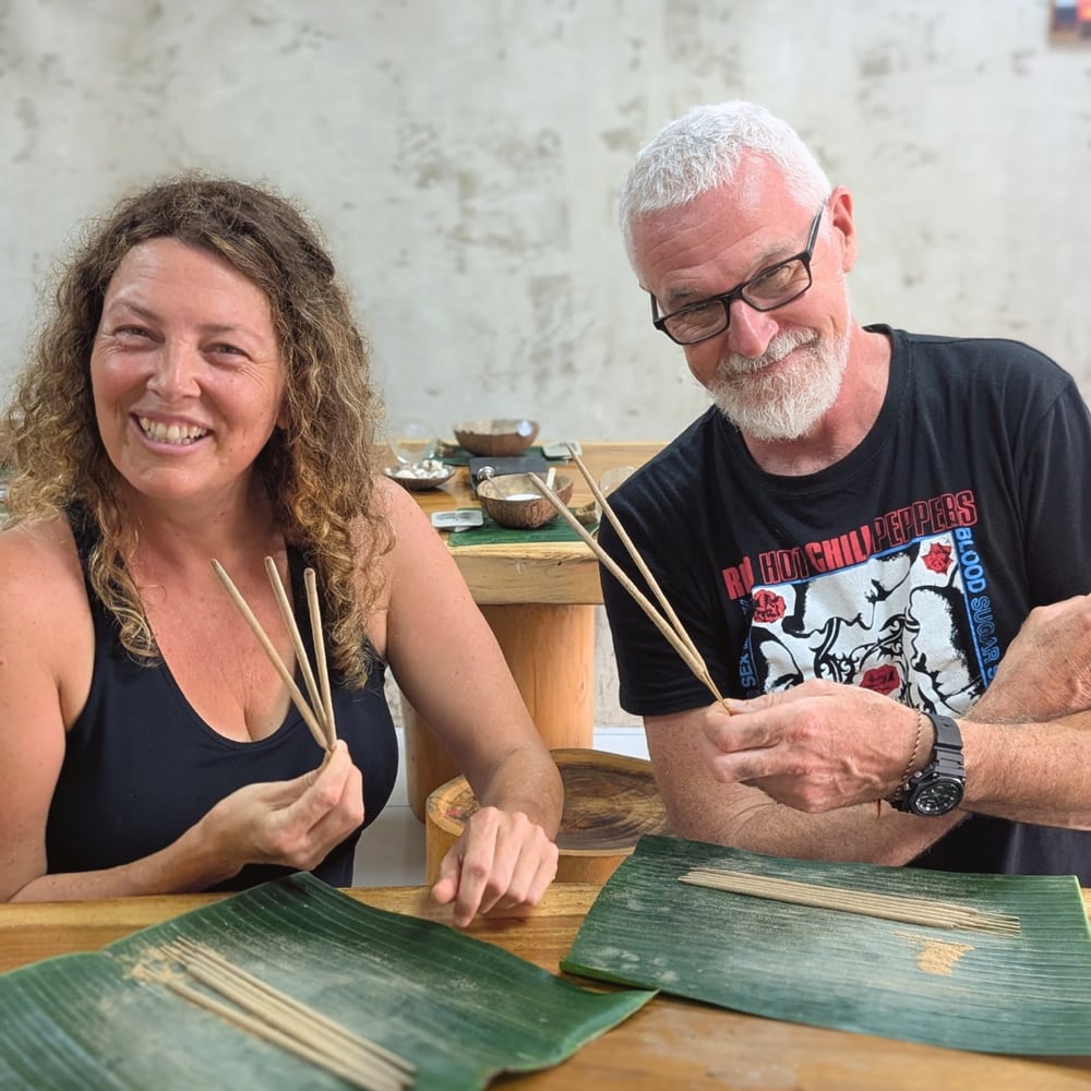 Workshop guests smiling with handmade incense sticks