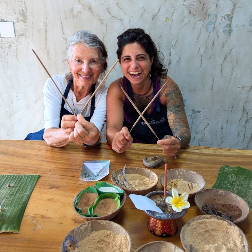 Two Sacred Smoke workshop guests holding incense sticks