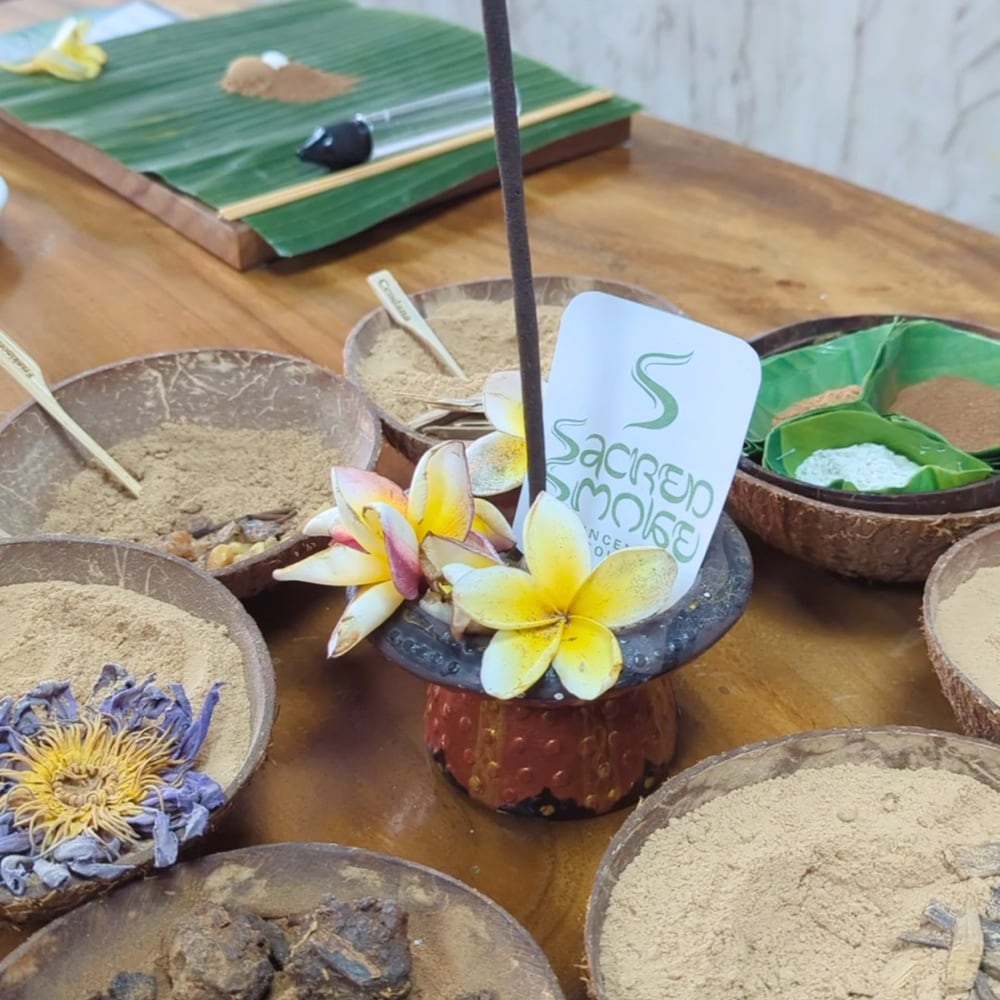 Incense burner and raw botanical powders on the Sacred Smoke table