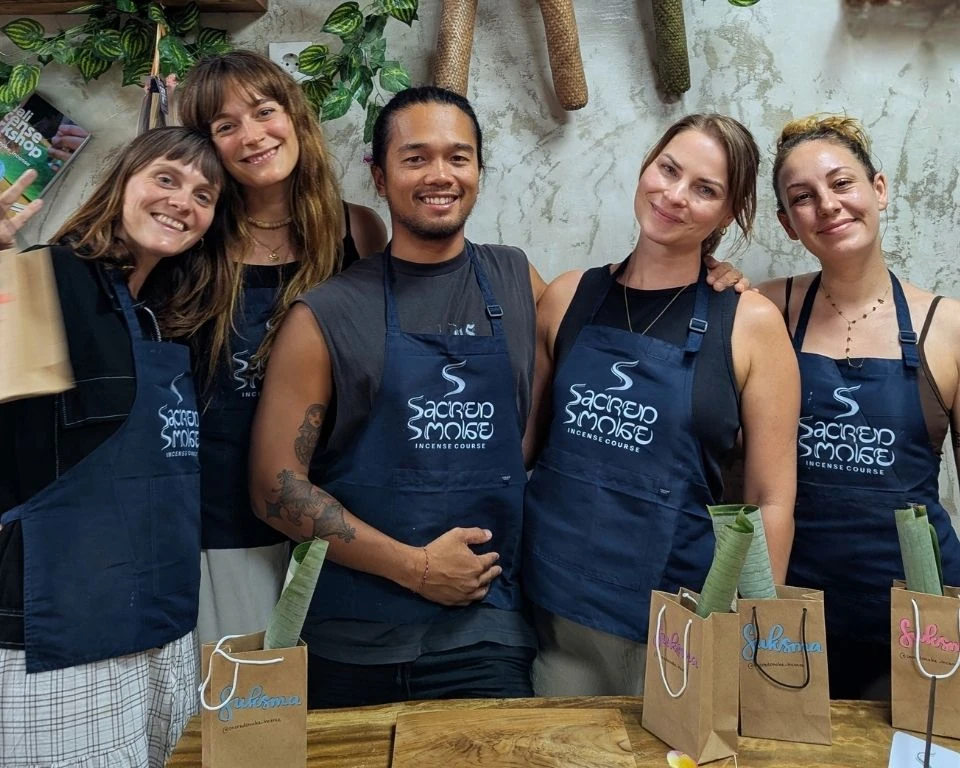 Five workshop guests in Sacred Smoke aprons with take-home bags