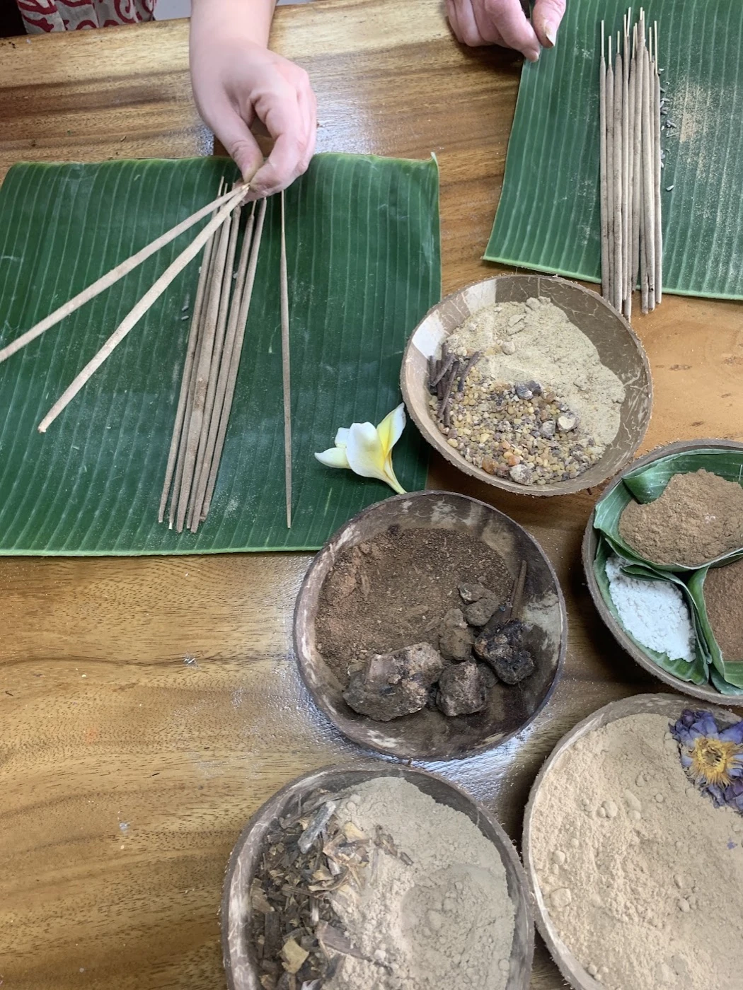 Hands preparing incense materials at the Sacred Smoke workshop in Ubud