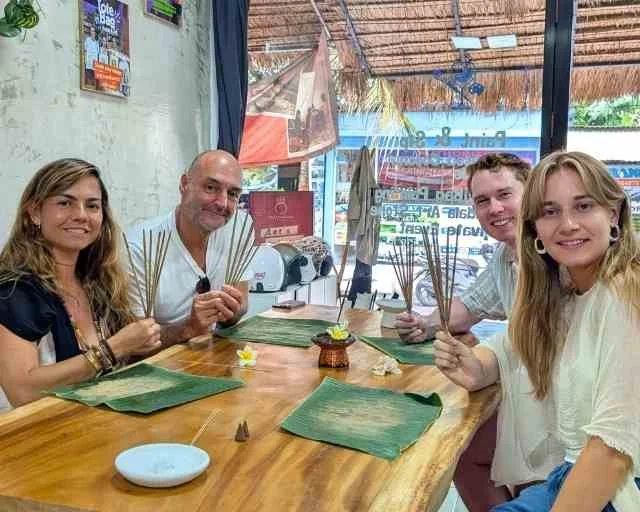 Workshop guests holding handmade incense sticks