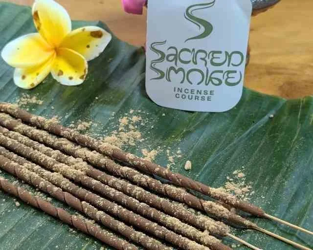 Finished Sacred Smoke incense sticks on a green leaf