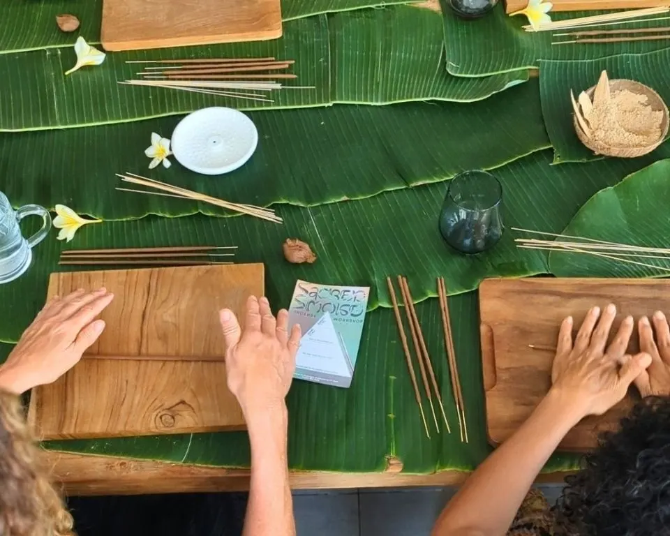 Guests practicing palm rolling on wooden boards