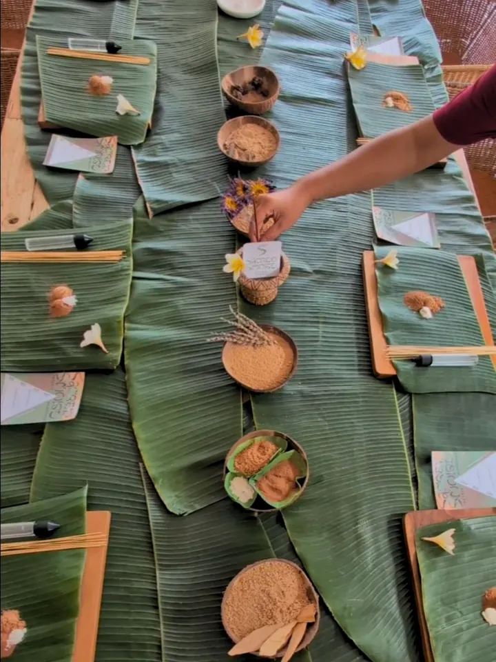 Botanical incense ingredients arranged around a private workshop table